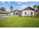 Charming one-story home featuring a well-manicured lawn and a long, paved driveway at 19395 Sheltered Hill Dr, Brooksville, FL 34601