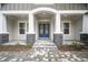 Elegant entryway showcasing a blue double door with glass inserts and stone accents at 19395 Sheltered Hill Dr, Brooksville, FL 34601