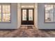 Welcoming entrance with elegant, dark double doors framed by large windows at 19395 Sheltered Hill Dr, Brooksville, FL 34601