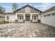 Inviting home entrance with a stylish blue double-door and stone pillar accents at 19395 Sheltered Hill Dr, Brooksville, FL 34601