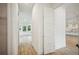 Hallway leading to a bright living area and modern kitchen at 19395 Sheltered Hill Dr, Brooksville, FL 34601