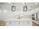 Bright kitchen featuring large island, stainless appliances, and ample white cabinetry at 19395 Sheltered Hill Dr, Brooksville, FL 34601