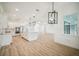 Open-concept kitchen featuring an island and stainless steel appliances, seamlessly flowing into the living space at 19395 Sheltered Hill Dr, Brooksville, FL 34601