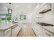 Modern kitchen with stainless steel appliances, island with seating and plenty of storage at 19395 Sheltered Hill Dr, Brooksville, FL 34601