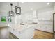 Bright kitchen featuring large island, stainless appliances, and ample white cabinetry at 19395 Sheltered Hill Dr, Brooksville, FL 34601
