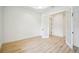 A bright office featuring wood floors, white walls, and natural light at 19395 Sheltered Hill Dr, Brooksville, FL 34601