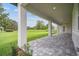 Covered patio with stylish brick pavers, offering a relaxing outdoor living space and green backyard views at 19395 Sheltered Hill Dr, Brooksville, FL 34601