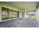 Spacious covered patio area showcases a view of the large sliding glass doors and well-maintained backyard at 19395 Sheltered Hill Dr, Brooksville, FL 34601