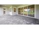View of the covered patio featuring sliding glass doors that open to the spacious backyard at 19395 Sheltered Hill Dr, Brooksville, FL 34601