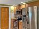 Stainless steel appliances and wood cabinets in this kitchen at 3439 Cockatoo Dr, Holiday, FL 34690