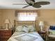 Spacious bedroom with a brass bed frame, and ceiling fan at 3439 Cockatoo Dr, Holiday, FL 34690