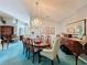 Formal dining room featuring a wood table, chairs, and a statement chandelier at 14155 Whitecap Ave, Hudson, FL 34667