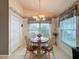 Bright dining area with a wooden table and chairs near a kitchen at 14155 Whitecap Ave, Hudson, FL 34667