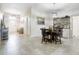 Open dining area with tile floors and breakfast bar at 14937 Potterton Cir, Hudson, FL 34667