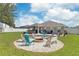 Fire pit and seating area in a spacious backyard at 14937 Potterton Cir, Hudson, FL 34667