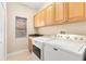 Laundry room with washer, dryer, and cabinets at 41 Cypress Dr, Palm Harbor, FL 34684