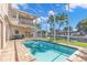 Screened-in pool with patio furniture and canal view at 41 Cypress Dr, Palm Harbor, FL 34684