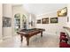 Game room featuring a pool table, bar stools, and large windows at 41 Cypress Dr, Palm Harbor, FL 34684