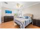 Bedroom with wood floors and blue and white bedding at 41 Cypress Dr, Palm Harbor, FL 34684