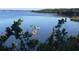 Peaceful lake view with people fishing from boats at 41 Cypress Dr, Palm Harbor, FL 34684