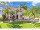 Two story house with palm trees and manicured lawn at 41 Cypress Dr, Palm Harbor, FL 34684