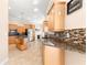 Kitchen with granite countertops and light wood cabinets at 41 Cypress Dr, Palm Harbor, FL 34684