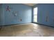 Blue bedroom with damaged walls and flooring at 3117 Laird Dr, New Port Richey, FL 34655