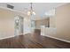 Open dining area with hardwood floors and views to living room at 4009 Cedar Crest Loop, Spring Hill, FL 34609