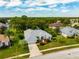 An aerial view of a single-Gathering home with a large yard and driveway at 4009 Cedar Crest Loop, Spring Hill, FL 34609