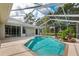 Inviting screened pool with waterfall feature at 4009 Cedar Crest Loop, Spring Hill, FL 34609