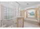 Bathroom with soaking tub, shower, and glass block window at 4009 Cedar Crest Loop, Spring Hill, FL 34609