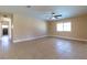 Large living room with tile floors and ceiling fan at 5036 Ivy Ct, North Port, FL 34287