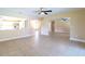 Spacious living room with tile floors and ceiling fan at 5036 Ivy Ct, North Port, FL 34287