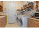 Laundry room with washer, dryer, and ample storage at 9312 Gentle Ben Ct, Weeki Wachee, FL 34613