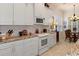 Bright kitchen with white cabinets and granite countertops at 9312 Gentle Ben Ct, Weeki Wachee, FL 34613