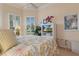 Bedroom with a floral comforter, ceiling fan, and built-in entertainment center at 9312 Gentle Ben Ct, Weeki Wachee, FL 34613