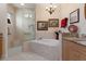 Elegant bathroom with soaking tub, walk-in shower, and granite vanity at 9312 Gentle Ben Ct, Weeki Wachee, FL 34613