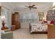 Main bedroom with wood furniture, ceiling fan, and large windows at 9312 Gentle Ben Ct, Weeki Wachee, FL 34613