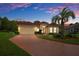 Single-Gathering home with brick driveway and palm tree at 9312 Gentle Ben Ct, Weeki Wachee, FL 34613