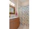 Guest bathroom with shower/tub combo and wood vanity at 9312 Gentle Ben Ct, Weeki Wachee, FL 34613