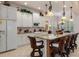 Spacious kitchen with white cabinets, granite island, and breakfast bar seating at 9312 Gentle Ben Ct, Weeki Wachee, FL 34613