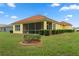 Landscaped backyard with a screened patio and lush green lawn at 9312 Gentle Ben Ct, Weeki Wachee, FL 34613