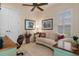 Home office with built-in desk and curved sofa at 9312 Gentle Ben Ct, Weeki Wachee, FL 34613