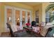 Wicker furniture and red flowers add charm to this outdoor patio at 9312 Gentle Ben Ct, Weeki Wachee, FL 34613
