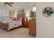 Main bedroom with wood furnishings and floral bedding at 9312 Gentle Ben Ct, Weeki Wachee, FL 34613