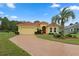 Single-Gathering home with brick driveway and palm tree at 9312 Gentle Ben Ct, Weeki Wachee, FL 34613