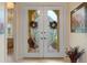 Bright entryway with double doors and stained glass at 9312 Gentle Ben Ct, Weeki Wachee, FL 34613