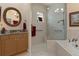 Bathroom features a walk-in shower, granite vanity, and a large mirror at 9312 Gentle Ben Ct, Weeki Wachee, FL 34613