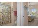 Guest bathroom with shower/tub combo and floral shower curtain at 9312 Gentle Ben Ct, Weeki Wachee, FL 34613