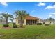 House with a screened-in patio and palm trees at 9312 Gentle Ben Ct, Weeki Wachee, FL 34613
